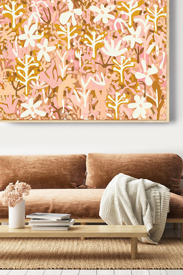 Living room with a brown sofa, coffee table, and abstract floral artwork on the wall.