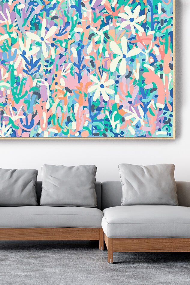 Colorful abstract painting on a wall above a gray sofa