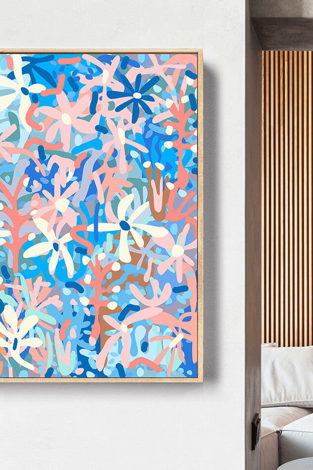 Abstract art print with blue, pink, and white colors on a light gray wall.